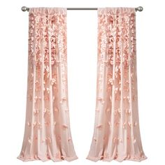 pink curtains with flowers on them hanging in front of a white wall