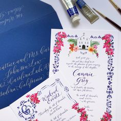 the wedding stationery is laid out on top of the table with paint and brushes