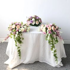 the table is covered with flowers and greenery for an elegant touch to the room