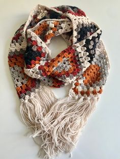 a multicolored crocheted scarf with fringes