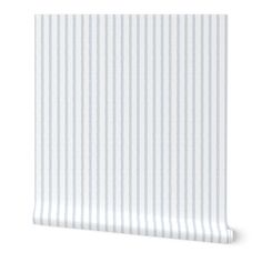 a white and blue striped wallpaper with vertical stripes on the bottom half of it