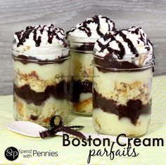 three jars filled with desserts sitting on top of a table