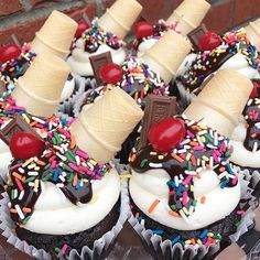 cupcakes with white frosting, chocolate and sprinkles on top