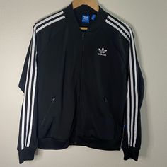 Us Size M, Never Worn! Good Condition. From Adidas Website. Urban Black Track Jacket With Long Sleeves, Urban Black Long Sleeve Track Jacket, Urban Style Long Sleeve Black Track Jacket, Black Long Sleeve Urban Track Jacket, Adidas Outerwear For Spring Streetwear, Adidas Spring Outerwear For Streetwear, Adidas Streetwear Outerwear For Spring, Adidas Spring Streetwear Outerwear, Adidas Urban Long Sleeve Track Jacket