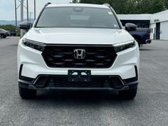 the front end of a white honda suv