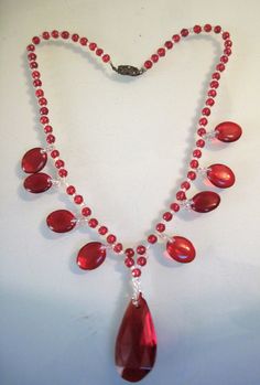 "Vintage art deco Red Glass Tear drop beaded Necklace the large stone in center has a small chip at top measures 18\" long large tear drop bead measures 1 1/2\" long" Vintage Red Teardrop Jewelry, Faceted Teardrop Red Jewelry, Vintage Red Beaded Necklaces With Oval Beads, Red Briolette Beads For Jewelry Making, Red Briolette Necklaces For Jewelry Making, Vintage Red Jewelry With Dangling Beads, Red Teardrop Necklace For Party, Red Briolette Gemstone Beads Necklace, Red Briolette Necklace With Faceted Beads