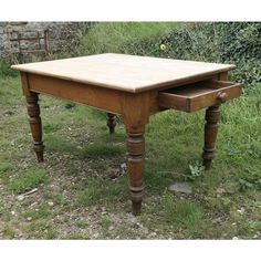 an old wooden table sitting in the grass