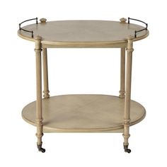 a round wooden table with wheels on the bottom and an oval shelf below it that has handles