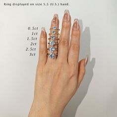 a woman's hand with five diamond rings on it