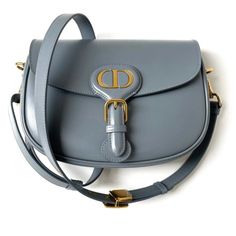 Shop marzie71's closet or find the perfect look from millions of stylists. Fast shipping and buyer protection. Dior Bobby Medium Cloud Blue Crossbody Shoulder Bag
Christian Bobby Medium shoulder bag and crossbody in Blue Cloud smooth box calfskin leather. Adjustable shoulder strap. Flap top with snap button closure. Soft Suede leather-lined interior with slip pocket. Gold-tone hardware. Made in Italy.

Condition: Mint condition
Includes: Protective felt insert, box, dustbag, cards, ribbon

... Dior Bag Outfit, Dior 30 Montaigne Bag, Dior Store, Blue Clouds, Soft Suede, 7 H, Luxury Handbags, Dior Bag, Crossbody Shoulder Bag