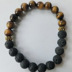 Nwt Lava Rock, Tiger Eye Beaded Bracelet. Lava Rock Is Made Of The Earth's Core And Is A Stone With A Special Connection To Mother Earth. This Is The Best Stone For Grounding, Stress Relief, Emotional Support, 8mm. For New Poshers, Enter Code Stephaniekj73 To Get $10 Off Your First Purchase! Casual Beaded Lava Stone Bracelets, Casual Black Lava Stone Beaded Bracelets, Casual Black Beaded Lava Stone Bracelets, Casual Brown Beaded Bracelets With Gemstone Beads, Casual Brown Gemstone Beads Bracelets, Casual Brown Bracelets With Gemstone Beads, Casual Brown Beaded Bracelets With Gemstones, Casual Hand-strung Brown Jewelry, Casual Brown Beaded Bracelets