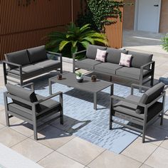 an outdoor patio furniture set with grey cushions