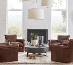 a living room filled with furniture and a fire place in front of a large window