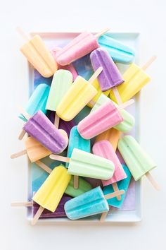 colorful popsicles are arranged on a square plate