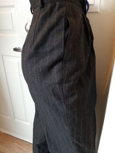 "Vintage Womens Wool High Waist Pleated Lined Pants Size 10 T/Curvey Excellent Vintage Condition. No Rips, Tears Or Stains. Shows Very Little Wear Made By Harve Benard by Benard Holtsman, Marked Size 10 Tall Dark Gray And White Pin Stripe Wool Fabric Dark Gray Satin Lining Fabric Possibly Nylon 6\" Gray Nylon Zipper 1.75\" Waistband And 5 Belt Loops, 2 Gray Buttons 2 Pleats On Each Side Front Hidden Side Pockets 4 Darts In Back Tapered Legs Roomy Through The Hips And Thighs Waist 29\" Hips 46\" Tailored Classic Knee-length Bottoms, Tailored Knee-length Formal Bottoms, Classic Knee-length Bottoms With Belt Loops, Classic Bottoms With Welt Pockets, Knee-length, Retro Fitted Bottoms For Office, Elegant Fitted Knee-length Pants, Vintage Tailored Bottoms For Formal Occasions, Vintage Fitted Pants For Business Casual, Vintage Bottoms For Business Casual In Fall