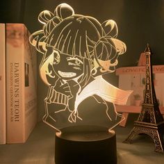 a lamp that is shaped like a girl in front of the eiffel tower