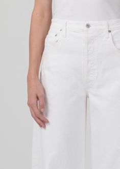 Aptly named, the Horseshoe jean is fashioned with a curved, wide leg that falls to slightly tapered and cropped, frayed hems. This oversized silhouette looks great with a sleek tank or tee. This fit is true to size. Looks Like: True, clean white with a raw frayed hemFeels Like: Non-stretch organic denim with a soft hand From our HUMANITY Collection Spring Cotton Tapered Cropped Jeans, Spring Tapered Cropped Cotton Jeans, Spring Cropped Tapered Cotton Jeans, White Relaxed Fit Cropped Jeans With Tapered Leg, Modern Cropped Bottoms With Relaxed Fit, Classic Tapered Leg Cropped Jeans For Summer, High Rise Tapered Cropped Jeans For Spring, Spring High Rise Tapered Cropped Jeans, Cropped Cotton Jeans