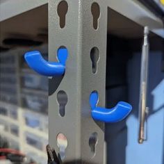 two blue handles are attached to the side of a metal structure