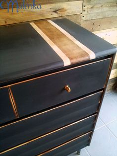 a black dresser with brown and white stripes on it