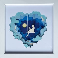 a paper cut sculpture of a girl swinging on a swing with the moon in the background