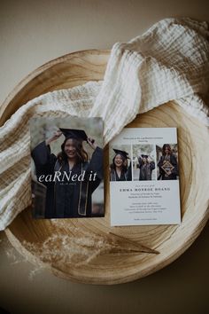 an open book and graduation card on top of a wooden bowl