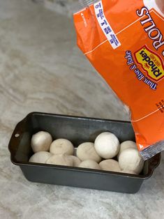 a package of mushrooms sitting on top of a counter next to a pan filled with them