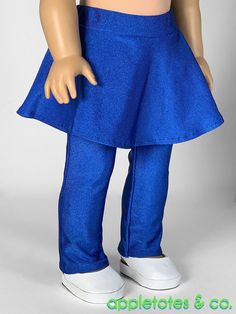 the doll is wearing a blue skirt and tennis shoes with her hands on her hips