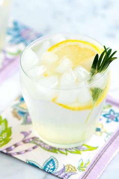 a drink with ice and lemon on a napkin