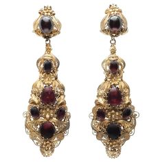 Early 19th Century Cabochon Garnet Drop Earrings c.1840s Composition: 15K Yellow Gold and Cabochon Garnets Color: 15K Yellow Gold Handmade Victorian Baroque Earrings For Formal Occasions, Victorian Baroque Earrings, Antique Earrings With 17 Jewels For Ceremonial Occasions, Victorian Jewelry With Historical Design For Evening, Antique Wedding Cabochon Earrings, Formal Filigree Baroque Earrings, Formal Baroque Filigree Earrings, Victorian Evening Earrings With 17 Jewels, Victorian Earrings For Evening