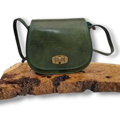 This stunning satchel bag comes in a soft emerald green leather, and has been made in Italy from the highest quality, soft leather and has a long 60cm adjustable strap which makes it an ideal cross body bag. It is a fully lined bag with one internal zip pocket. The bag features a zip closure, with an over-flap and toggle closure for additional security and style  Full features of this beautiful bag, include: * Flap Over closure with toggle system closure. * Top zip closure. * Old brass tone meta Green Leather Shoulder Bag, Classic Green Shoulder Bag For Travel, Classic Green Bag For Daily Use, Green Satchel With Adjustable Handle For Everyday, Green Soft Leather Shoulder Bag For Everyday Use, Green Satchel Saddle Bag For Travel, Green Leather Flap Bag For Everyday Use, Green Satchel With Adjustable Strap For Everyday, Green Soft Leather Satchel Flap Bag