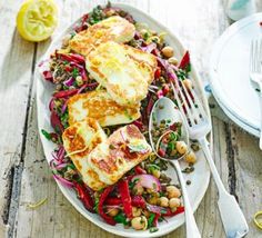 a white plate topped with fish and vegetables