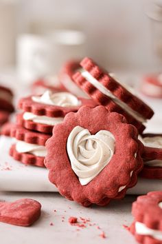 red velvet cookies with white frosting in the shape of hearts