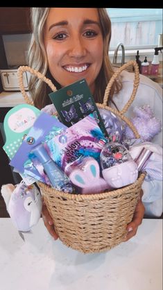 a woman holding a basket filled with lots of items