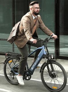 a man in a suit riding a bike down the street with a bag on his back