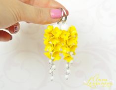 "Yellow earrings Yellow floral earrings gift White yellow long earrings Yellow polymer earrings Bright flower earrings Yellow wedding jewelry Flowers Long earrings with Yellow flowers, and supplemented with White glass beads. These earrings are perfect for a bride if you are having a yellow wedding. The earrings are great for the bridesmaid. Bright floral earings will be a perfect gift for her Accentuate your individuality with the help of these floral earrings! Yellow Flowers Lilacs, made of polymer clay. For these flowers I used high quality polymer clay Fimo. Each flower is made by hand in a special technique. The last photo shows the bracelet. A similar bracelet can be made to match your earrings. Length with hooks is about 8 cm/3.15\" ✿ THESE EARRINGS ARE READY TO SHIP! ✿ Real colors Elegant Yellow Dangle Flower Earrings, Yellow Earrings With 3d Flowers As A Gift, Elegant Yellow Flower Earrings For Wedding, Yellow Flower-shaped Earrings With 3d Flowers, Yellow Flower Earrings With 3d Flowers, Yellow Flower Drop Earrings For Wedding, Handmade Yellow Flower Earrings For Gift, Yellow Handmade Flower Earrings For Gift, Handmade Yellow Flower Earrings For Wedding