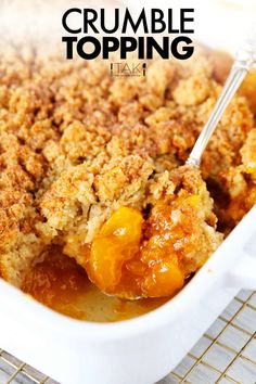 a close up of a casserole dish with peaches and crumbs