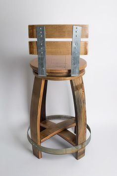 a wooden stool with metal straps on it