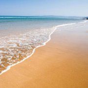 an ocean beach with waves coming in to shore