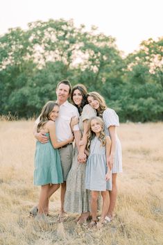 a family posing for a photo in a field