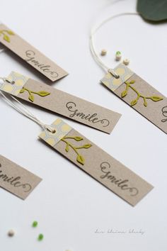 three name tags with flowers and leaves on them