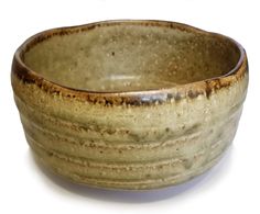 a brown and white bowl sitting on top of a table