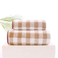 two brown and white towels sitting on top of each other