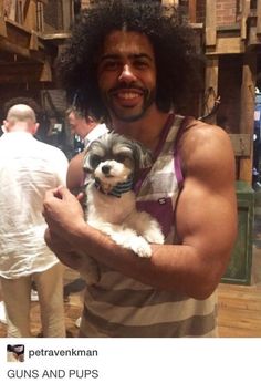 a man holding a small dog in his arms