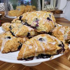 blueberry scones with icing on a white plate