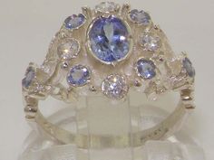 a yellow gold ring with blue and white stones