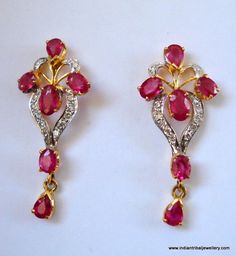 14k GOLD EARRINGS EAR STUD FROM RAJASTHAN INDIA, GREAT HANDMADE DESIGN MADE OF 14K YELLOW GOLD SATED REAL A QUALITY RUBY & DIAMOND GEM STONES, NICE PIECE GOOD FOR JEWELRY COLLECTION.Height max. - 2.8 cm(1.1")width max. - 1.2 cm(0.47")Total weight - 3 gramsMaterial - 14 carat solid yellow gold & real gem stones. Traditional 17 Jewel Diamond Earrings For Gift, Red Ruby Diamond Earrings For Wedding, Traditional Diamond Earrings With Gemstone, Traditional 17 Jewel Diamond Earrings For Anniversary, Ruby Yellow Gold Earrings For Celebration, Red Diamond Earrings With Accents For Wedding, Yellow Gold Ruby Earrings With Diamond Accents, Red Diamond Hallmarked Earrings, Temple Jewelry Style Ruby Earrings In Yellow Gold