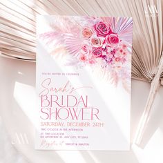 a bridal shower party with pink flowers and palm leaves