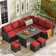 an outdoor patio furniture set with red cushions and matching pillows on the outside deck area