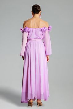 the back of a woman wearing a purple dress with long sleeves and flowers on it