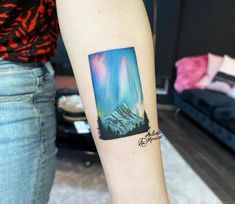 an aurora bore tattoo on the arm